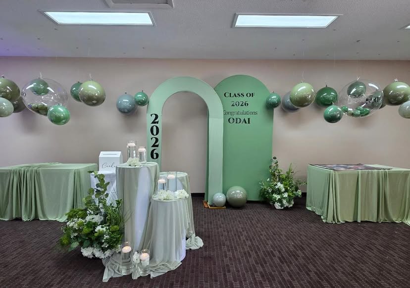 Full room transformation with hanging balloons and draped tables